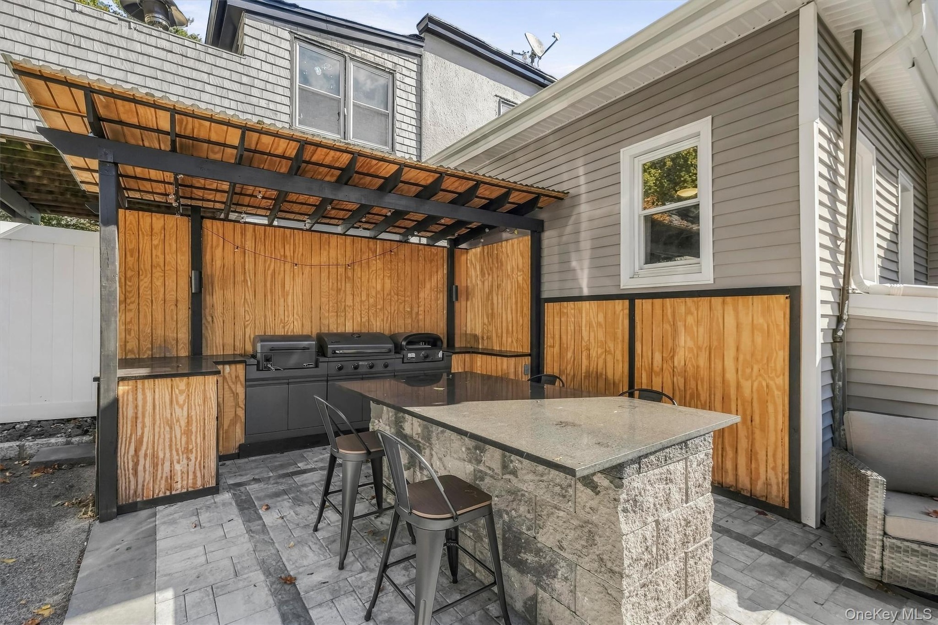 Incredible outdoor entertaining space complete with a fully equipped backyard kitchen and a built-in pizza oven, perfect for hosting weekend gathering