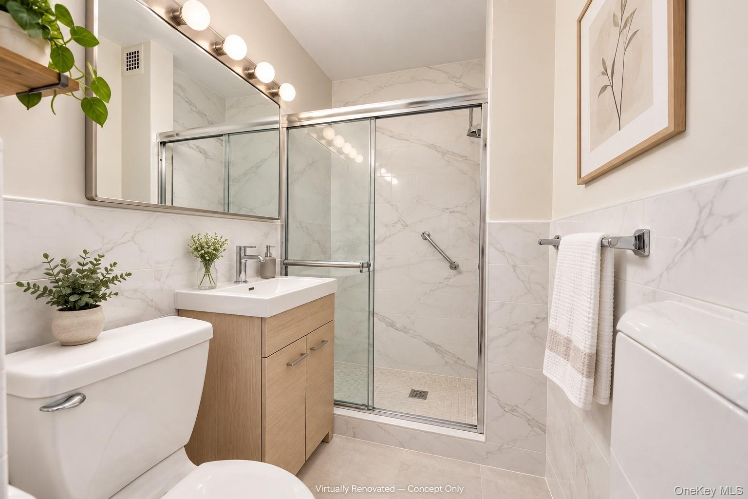 Bathroom featuring light wood-finish vanity, large wall-mounted mirror, walk-in shower with glass sliding door, and stone-tile wall surround