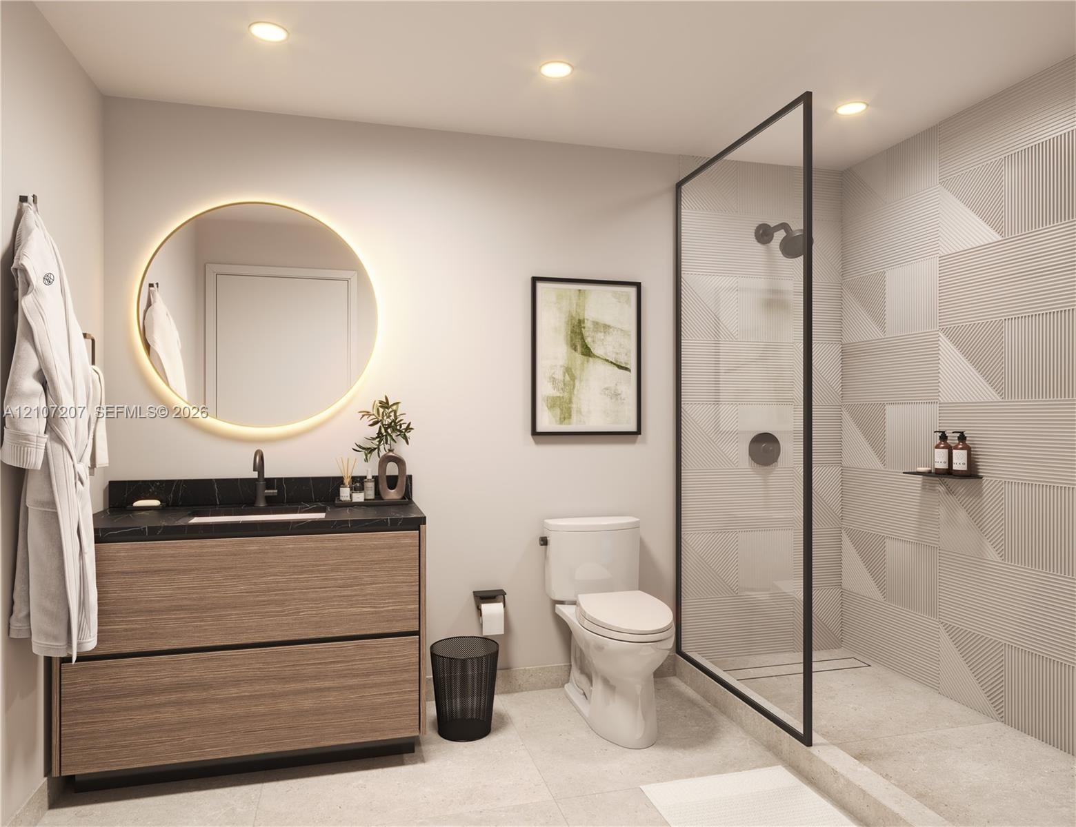 Modern vanity with wood-finish cabinetry, dark stone-style countertop, circular backlit mirror, and walk-in shower featuring glass enclosure, matte bl