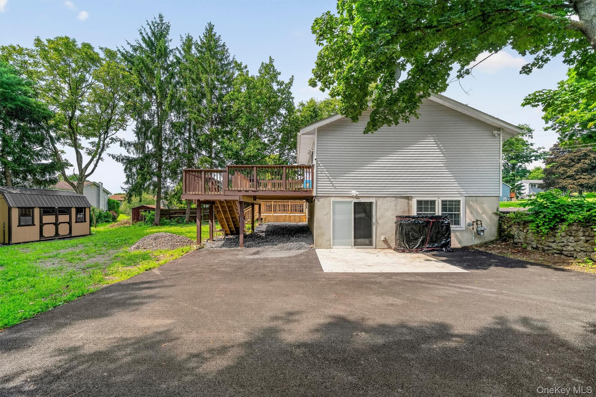 More driveway space and entrance to lower level apartment area.