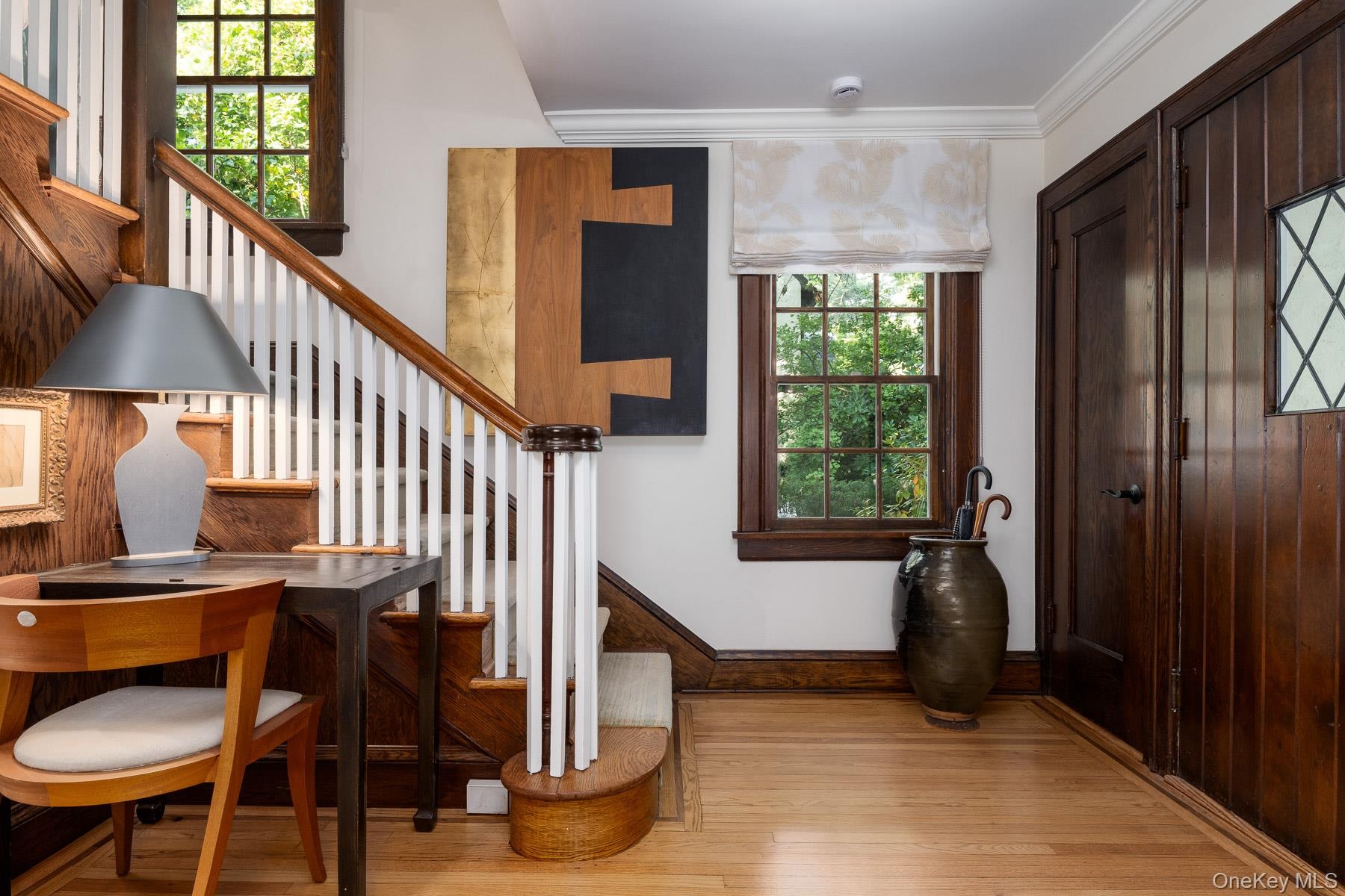 Entrance hall featuring two closets and hardwood floors.
