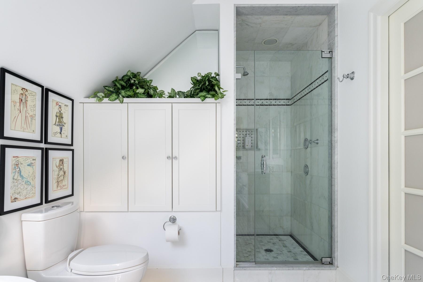 Ensuite featuring separate shower and built-in cabinetry.