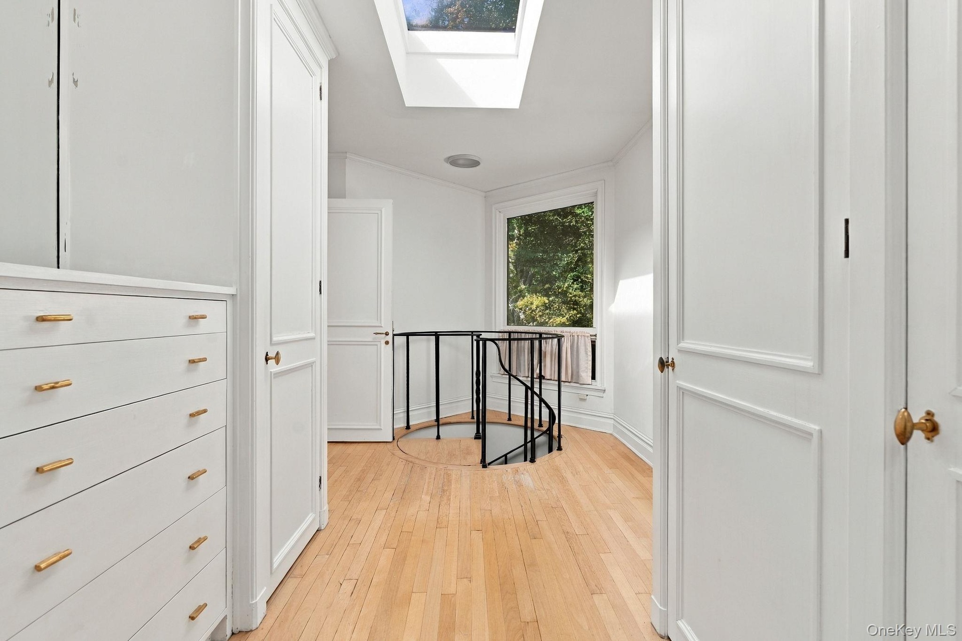 Main Floor Original Primary Suite Hexagon Bedroom Wing. Dressing Room with Built-Ins. Spiral Staircase down to another Hexagon Room with Bath and door