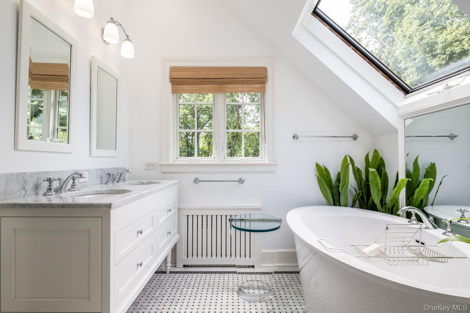 Luxurious Ensuite bathroom featuring a skylight and soaking tub.