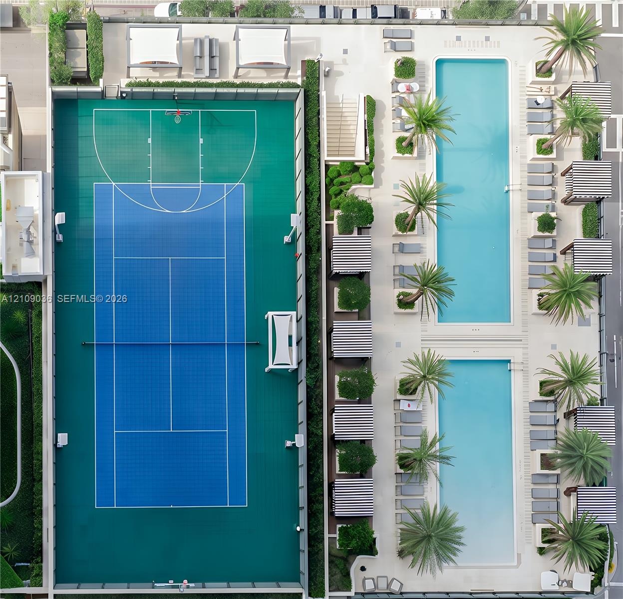 Recreational amenities featuring a multi-sport court with basketball and tennis markings, two rectangular swimming pools, and landscaped areas with pa