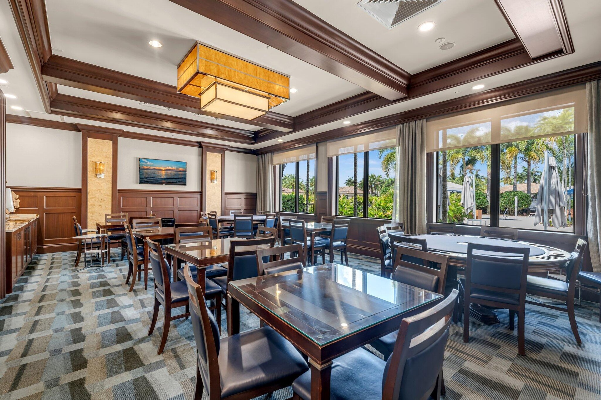Elegant dining room showcasing coffered ceiling with decorative wood beams, recessed lighting, and a geometric patterned floor