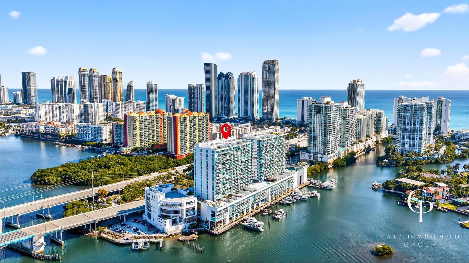 High-rise waterfront property featuring glass-front balconies, integrated marina boat slips, and panoramic coastal and skyline exposure