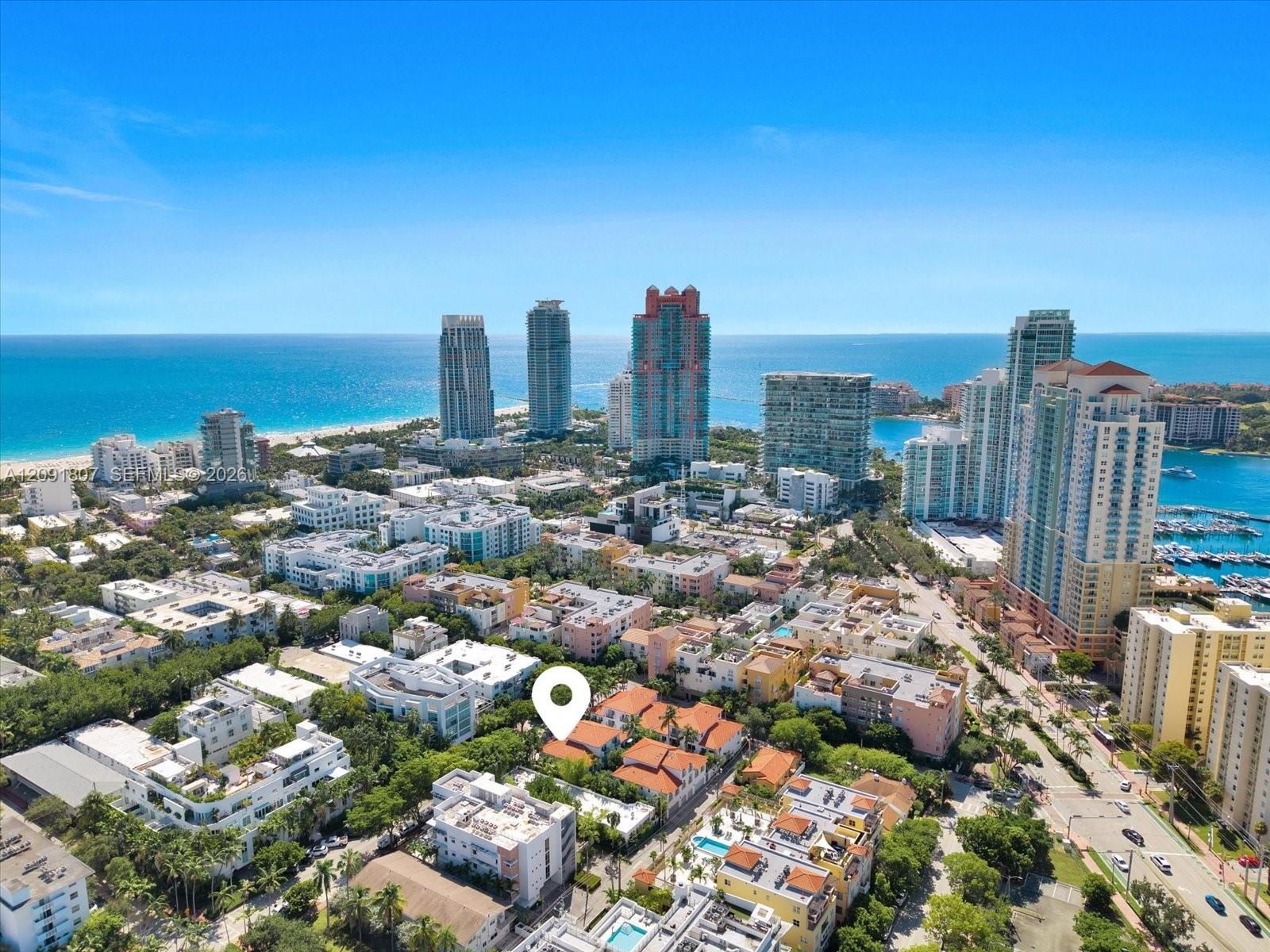 Aerial perspective featuring a low-rise residential complex with terracotta-style roofing, situated within a dense urban landscape featuring proximity