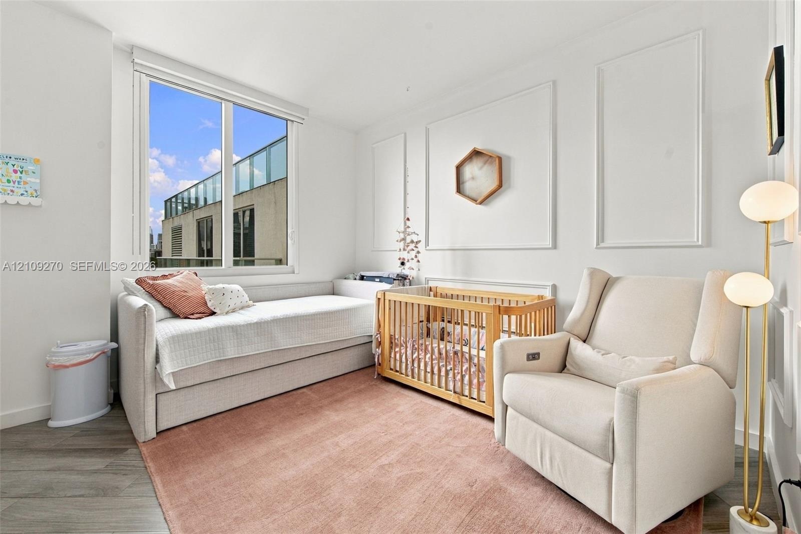Interior space featuring wood-finish flooring, decorative wall molding, and a large window