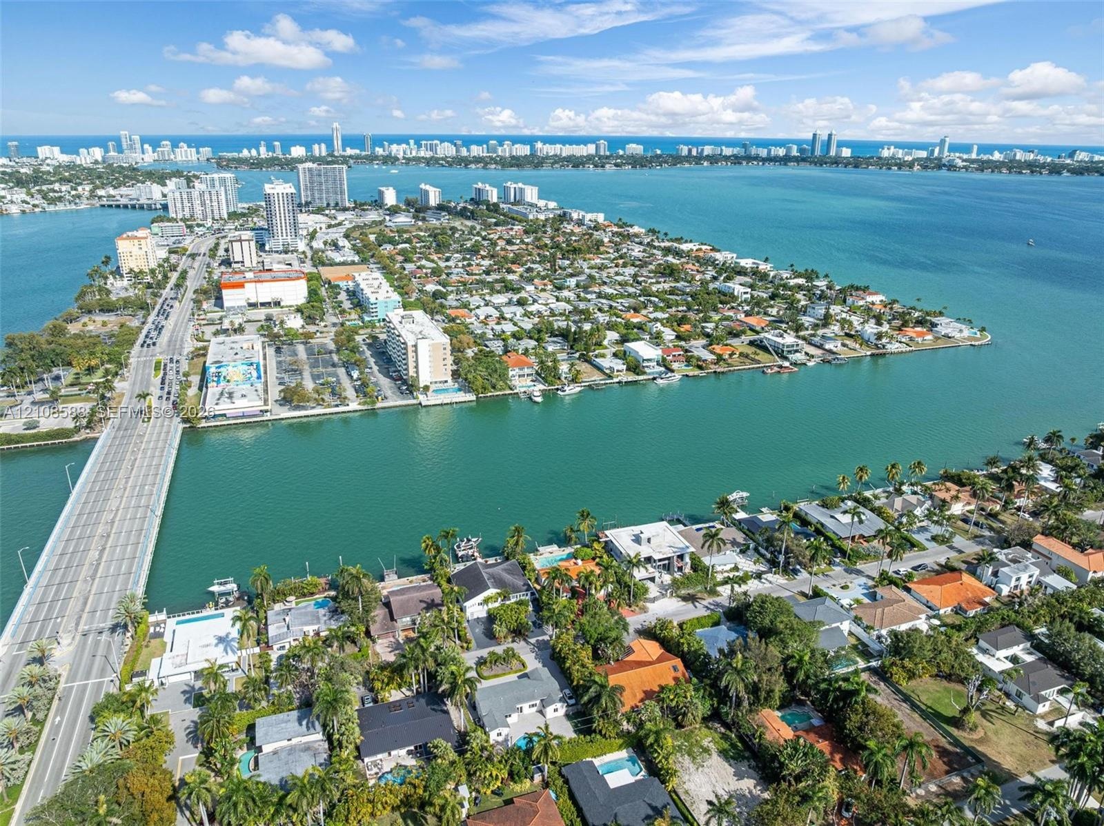 Aerial perspective of a coastal peninsula featuring extensive waterfront property lines, deep-water access, mature tropical vegetation, and proximity 