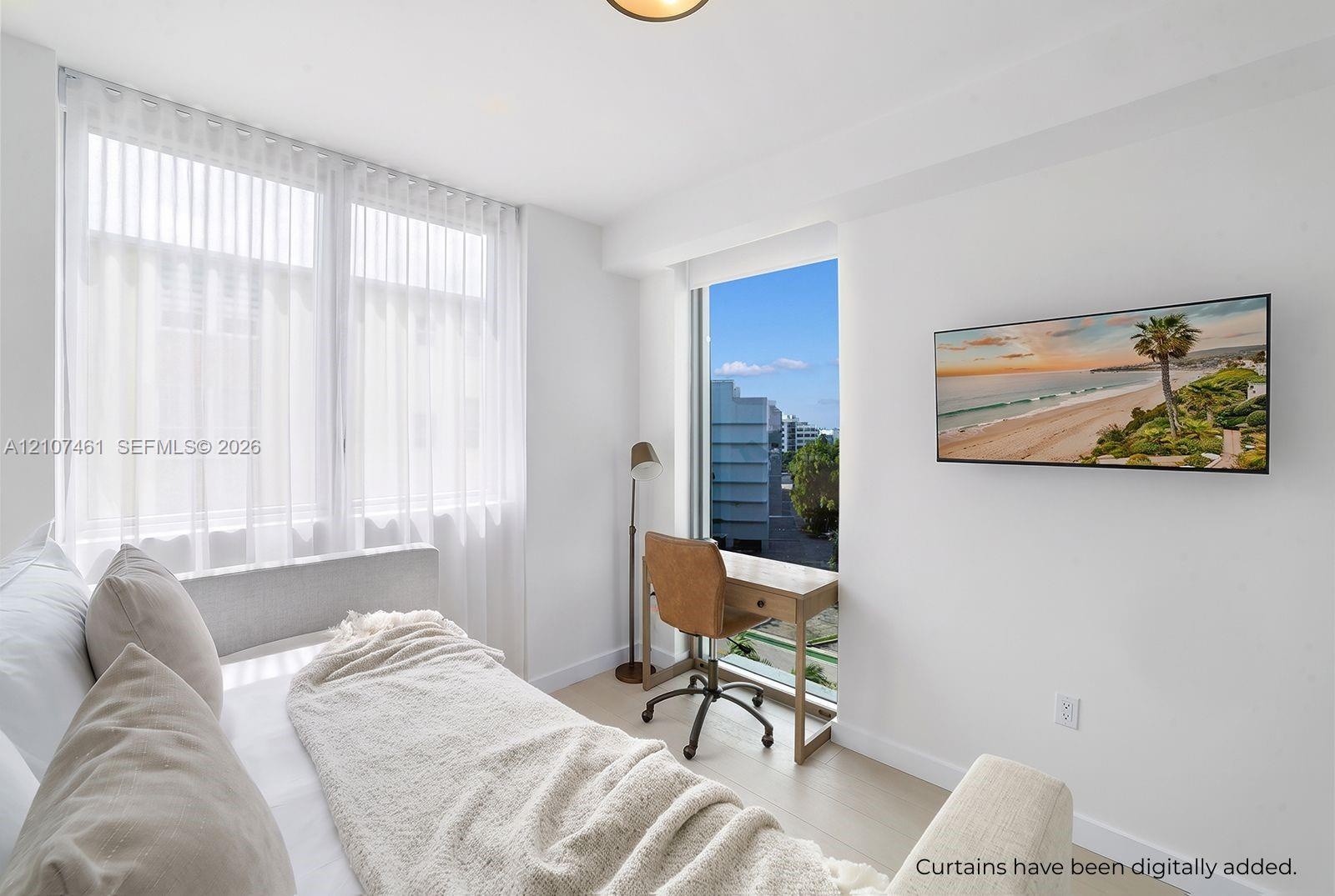 Bright interior featuring large floor-to-ceiling windows, light-toned wood-finish flooring, and crisp white walls