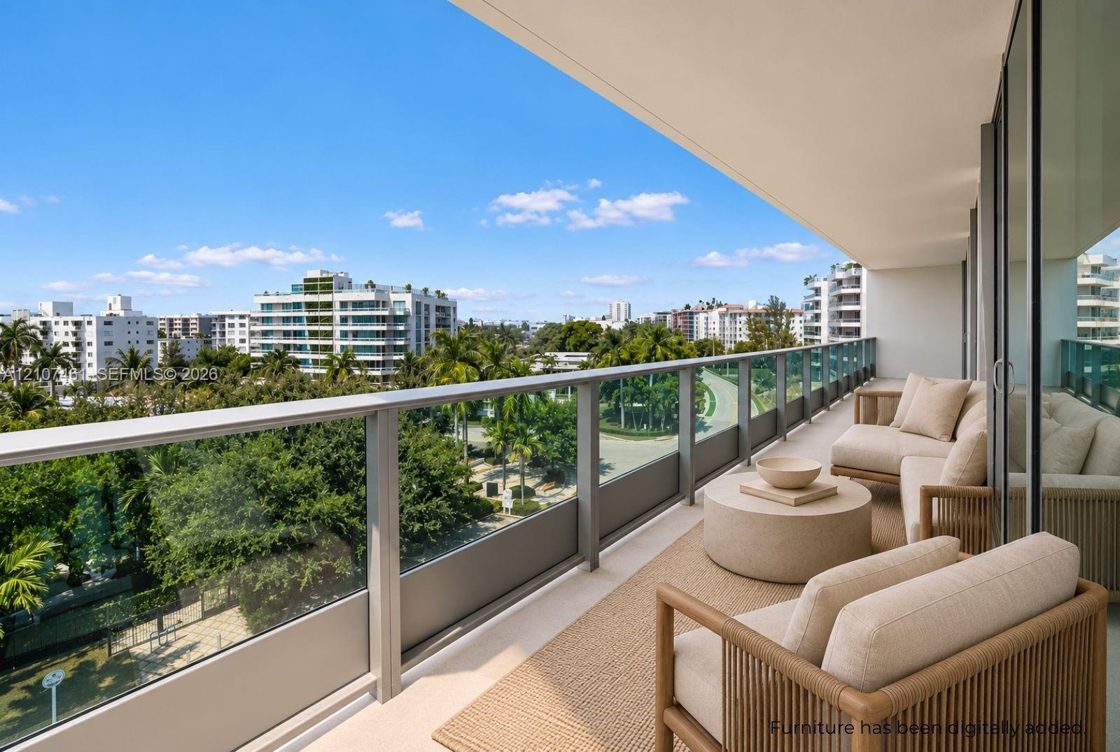 Covered balcony featuring a sleek glass-panel railing, overhead lighting, and expansive urban scenery