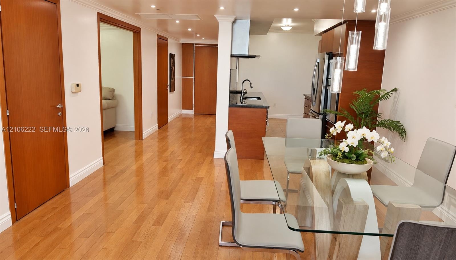 Interior featuring wood-finish flooring, recessed lighting, and kitchen cabinetry with integrated stainless steel appliances