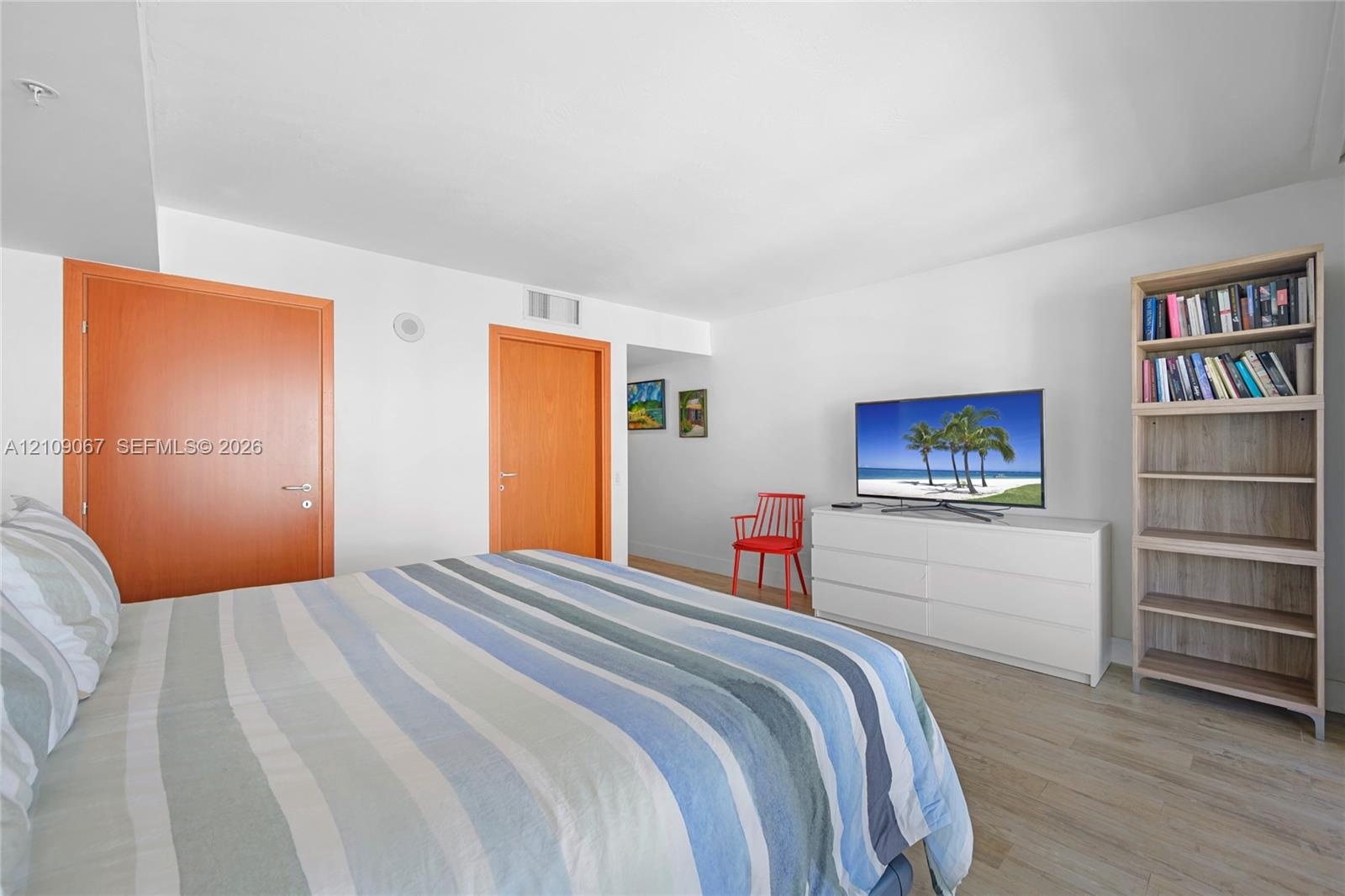 Neutral wall palette featuring wood-finish flooring and solid core wood doors