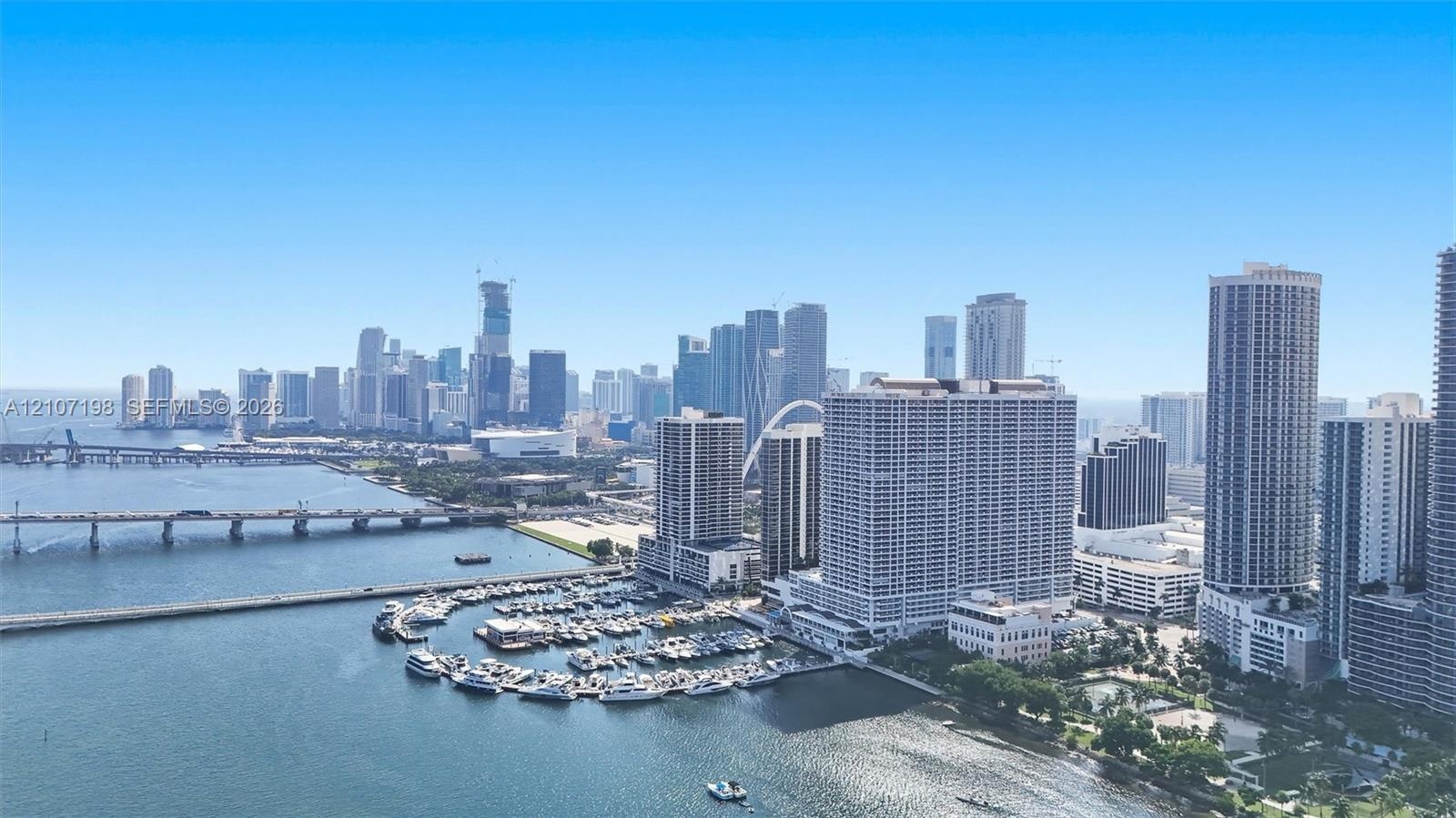 Panoramic urban skyline featuring expansive waterfront exposure, a deep-water marina, and extensive bridge infrastructure