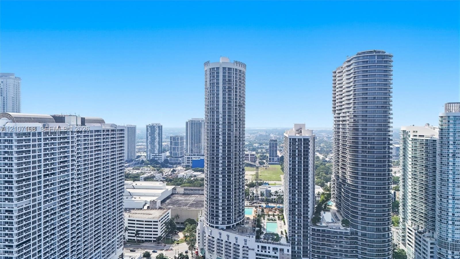 High-rise urban landscape featuring glass-facade residential towers, expansive city skyline, and multi-level architectural density