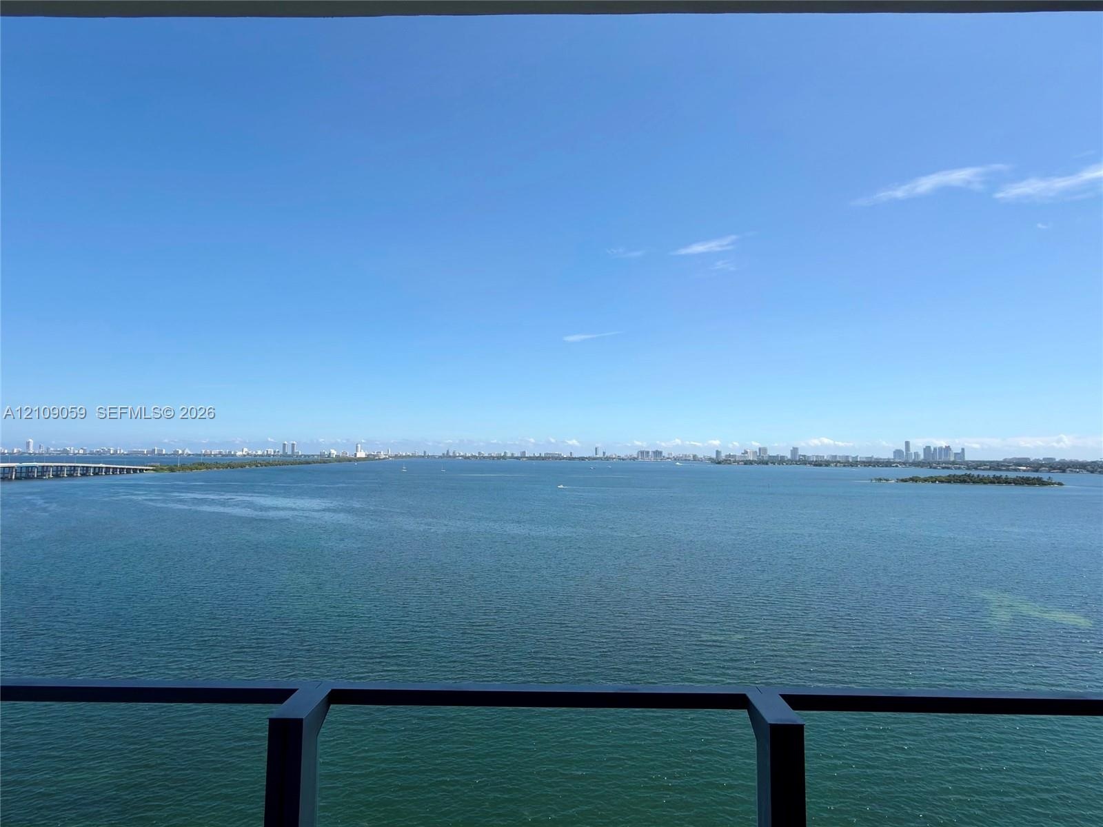 Elevated balcony featuring a dark metal railing with expansive, unobstructed water scenery