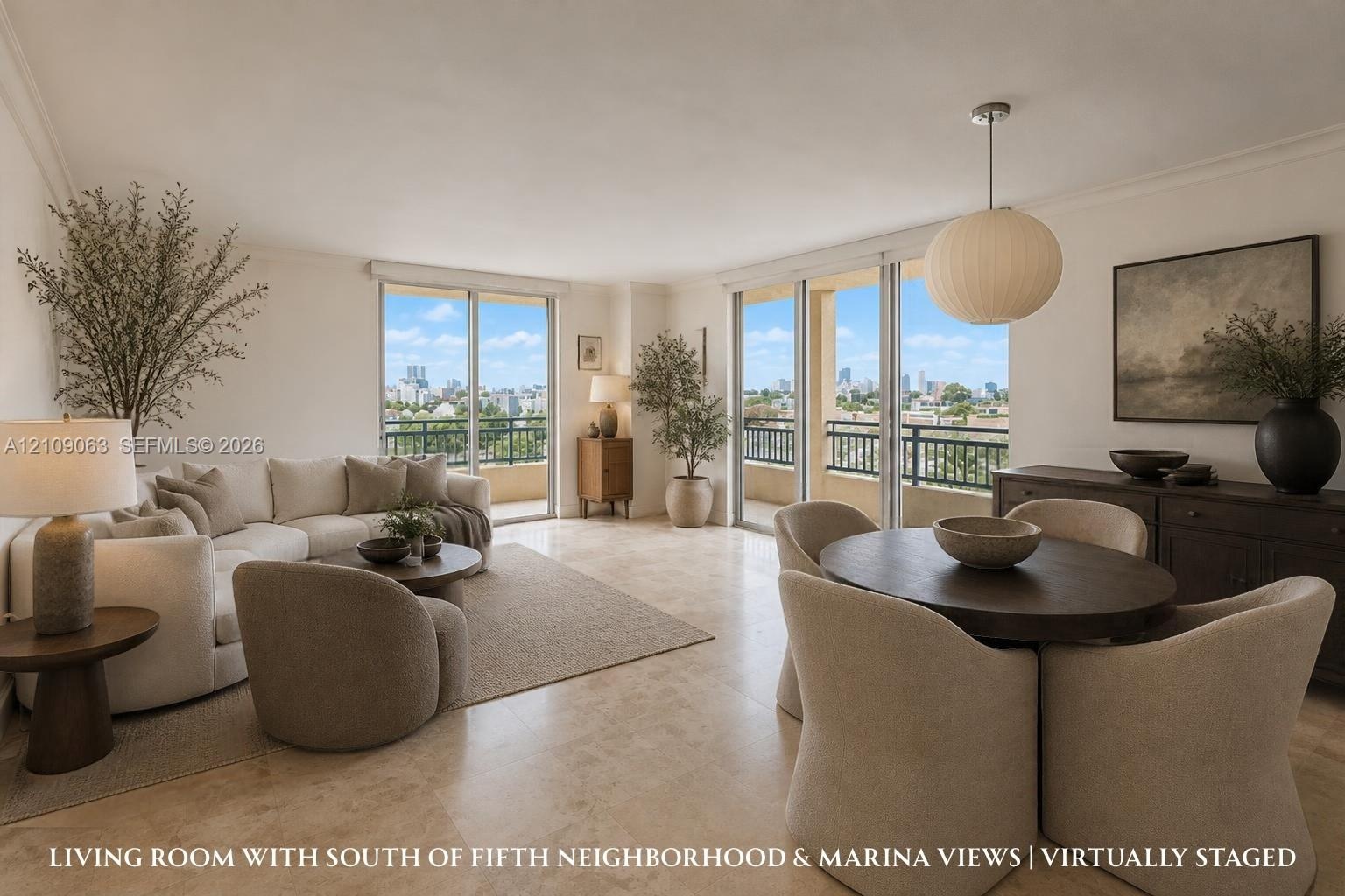 Open-concept interior featuring light-toned stone tile flooring, dual floor-to-ceiling glass sliding doors, a suspended spherical light fixture, and a