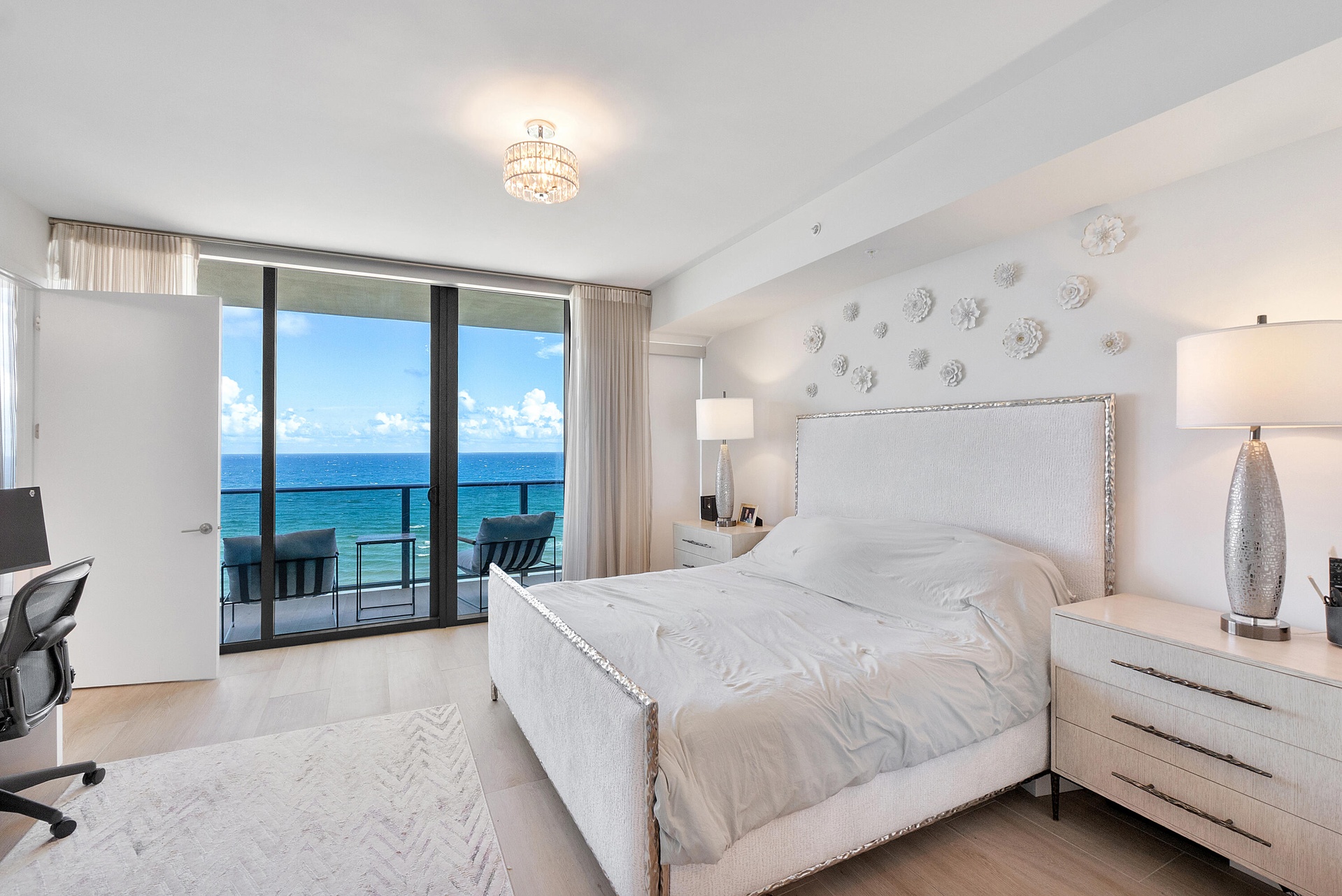 Wake up to breathtaking Atlantic Ocean views in this luxurious primary suite, offering floor-to-ceiling glass, generous proportions, and a serene coas