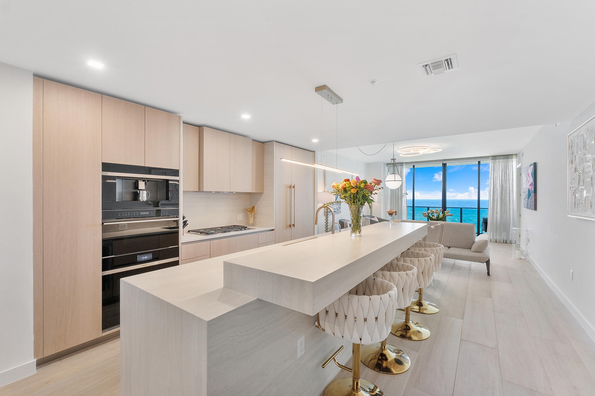A stunning designer kitchen featuring sleek contemporary cabinetry, premium finishes, and an expansive island, perfectly complemented by breathtaking 