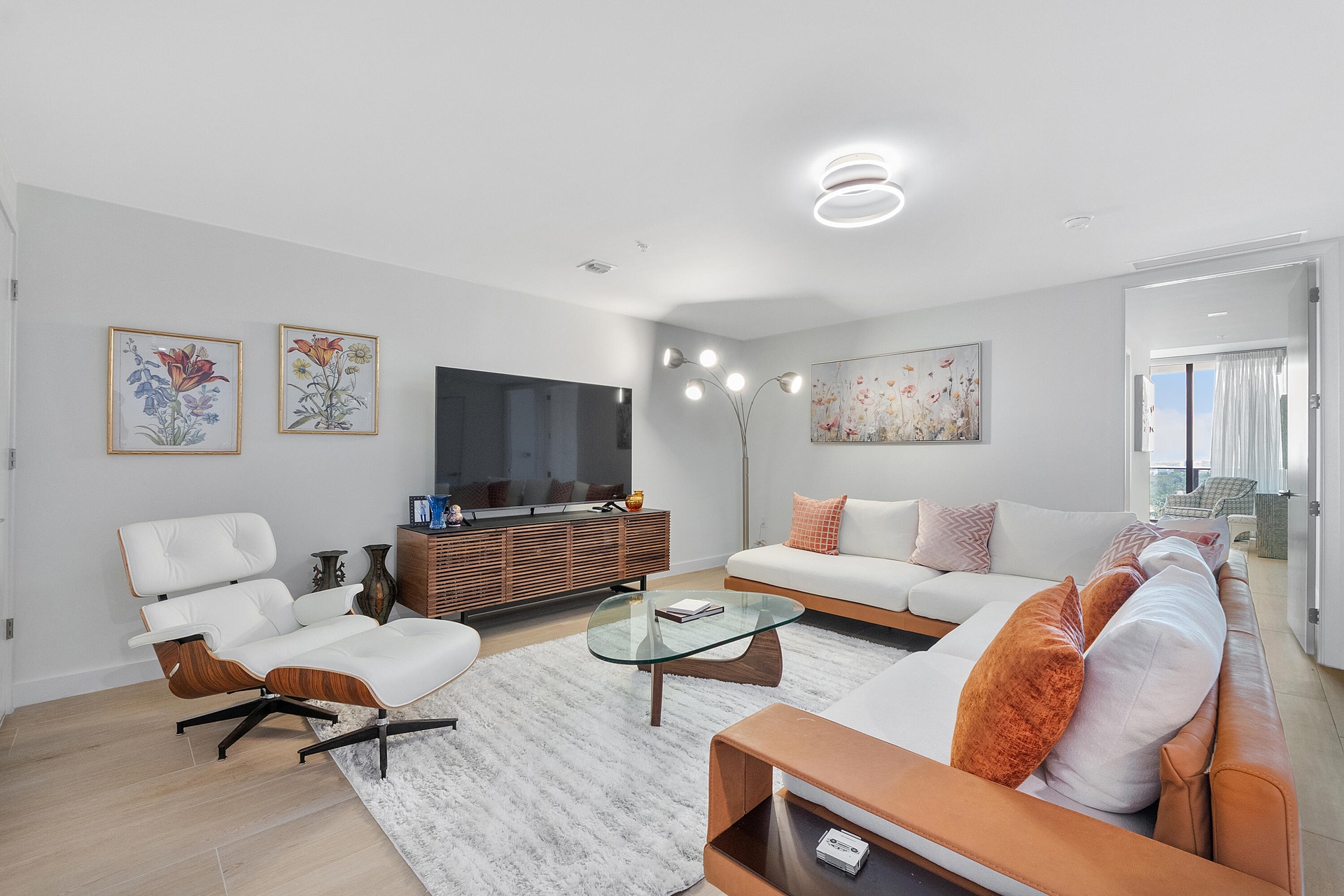 An inviting living area featuring elegant contemporary furnishings, abundant natural light, and a spacious layout designed for effortless entertaining