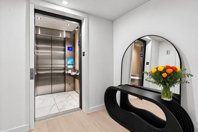 An elegant private elevator foyer welcomes you home with sophisticated architectural details and a striking designer console, setting the tone for lux