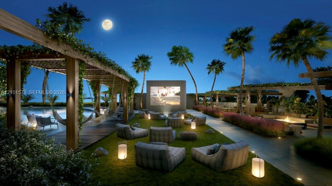 Outdoor movie theater, with hammock, sofas and lawn to enjoy movies under the stars