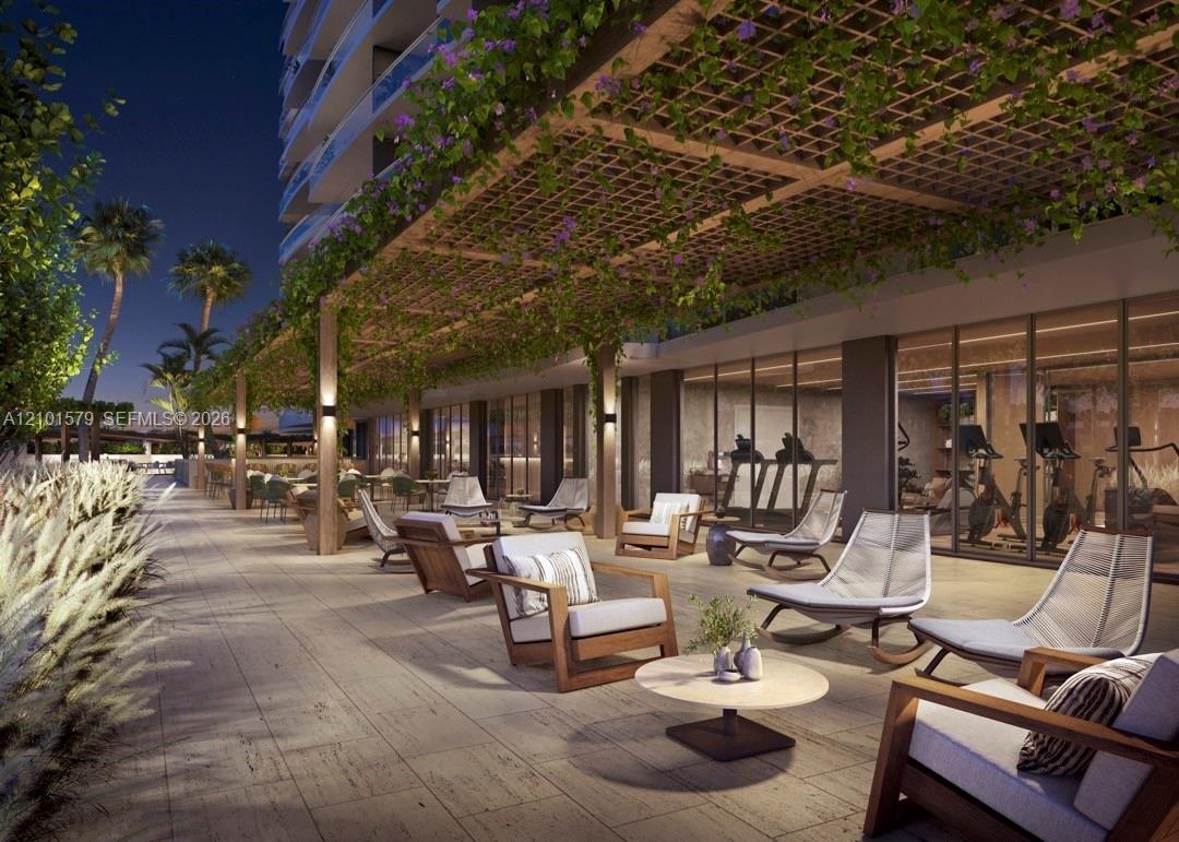 Covered outdoor bar and patio featuring an overhead pergola, integrated landscape, stone-tiled flooring, and recessed wall-mounted lighting