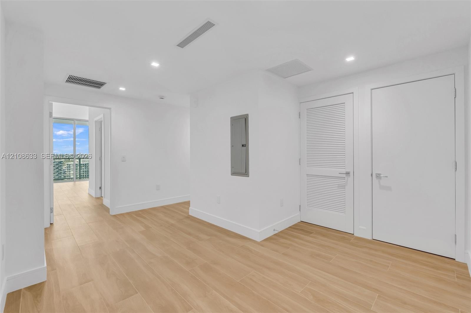 Interior space featuring wood-finish flooring, recessed lighting, and a louvered closet door