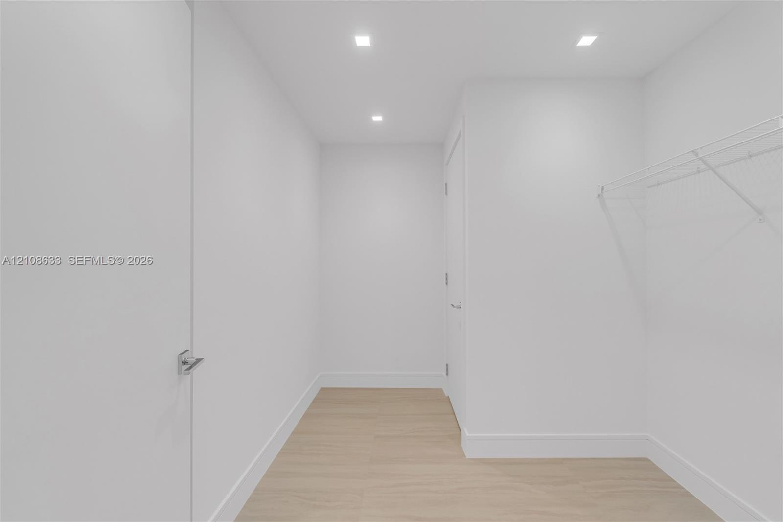 Storage area featuring recessed lighting, white walls, wood-finish flooring, and wire shelving