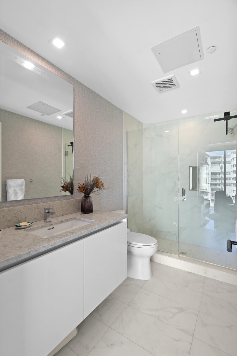 Guest bedroom 2 features more designer touches, automated blinds, customized closet, murphy bed and ensuite bathroom.