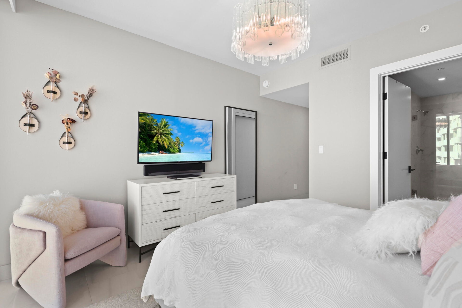 Guest bedroom 1 features more designer touches, automated shades & blinds, customized closet, and ensuite bathroom.