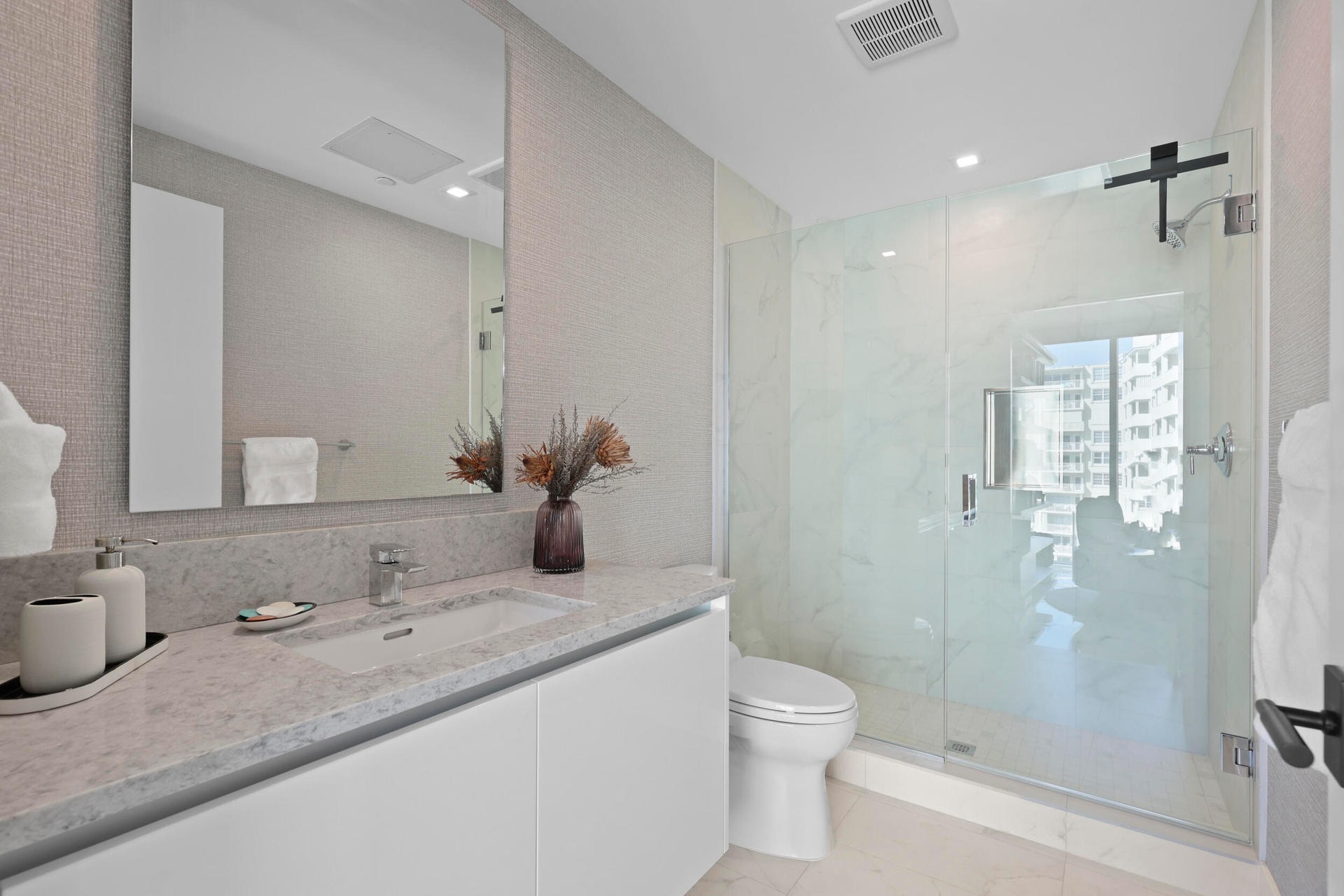 Guest bedroom 2 features more designer touches, automated blinds, customized closet, murphy bed and ensuite bathroom.