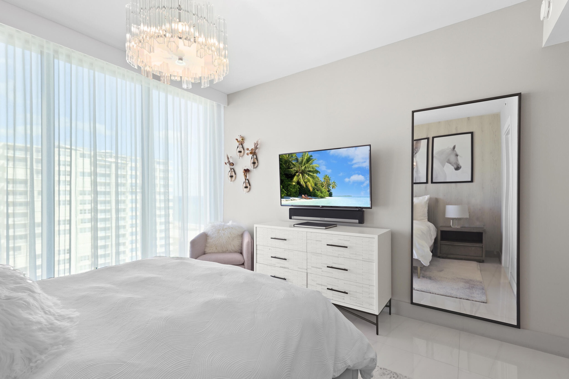 Guest bedroom 1 features more designer touches, automated shades & blinds, customized closet, and ensuite bathroom.