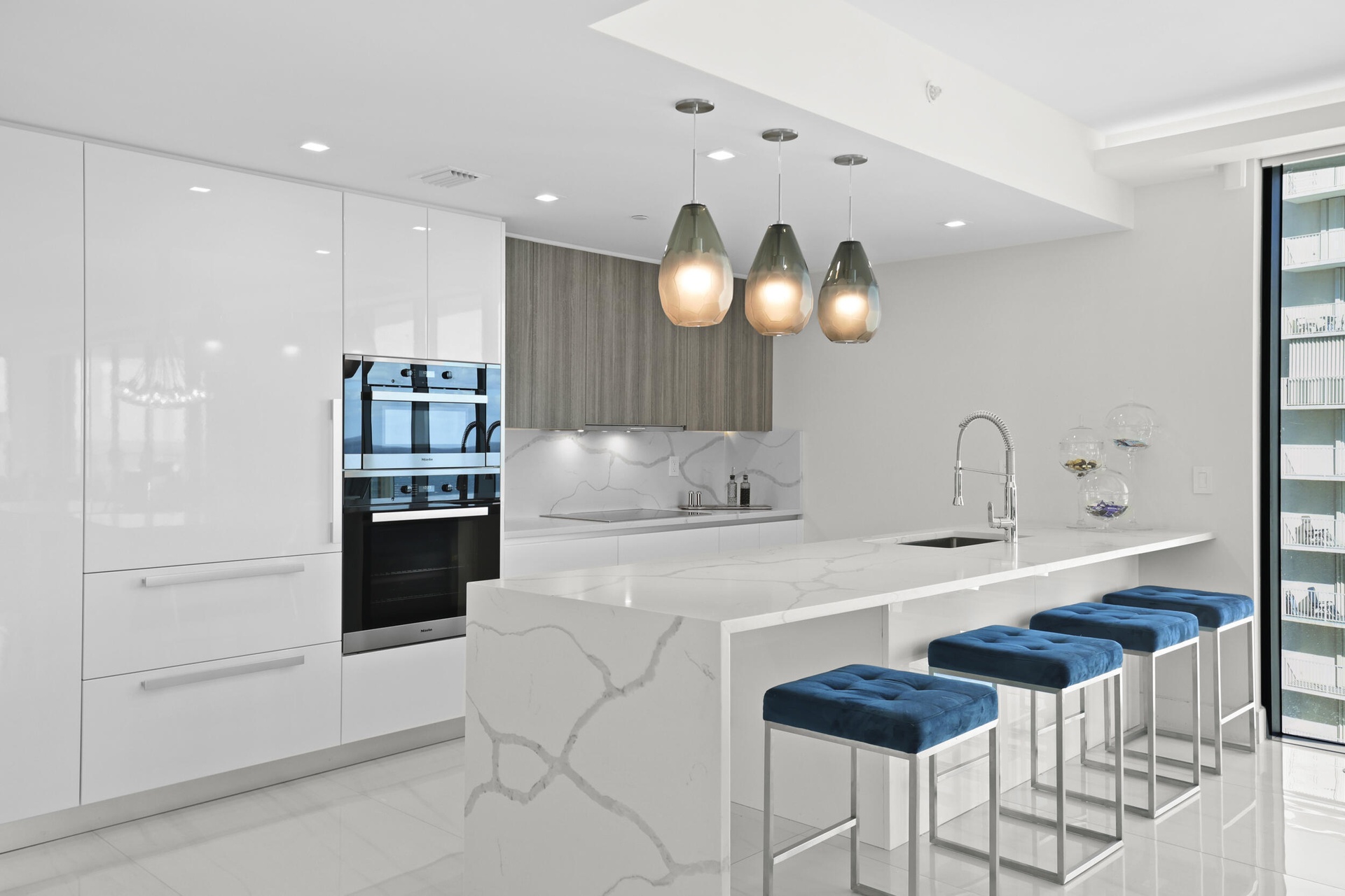 Culinary enthusiasts will enjoy a true chef's kitchen, highlighted with custom Italian cabinetry, Quartz countertops, and luxury (SubZero & Miele) app