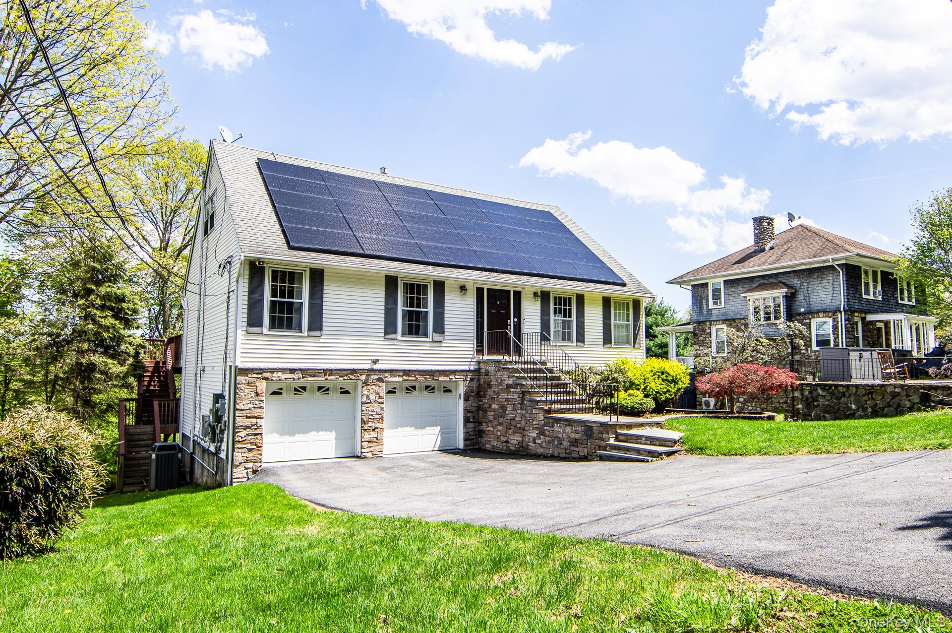 Welcome Home to this Contemporary cape with vinyl and stone front