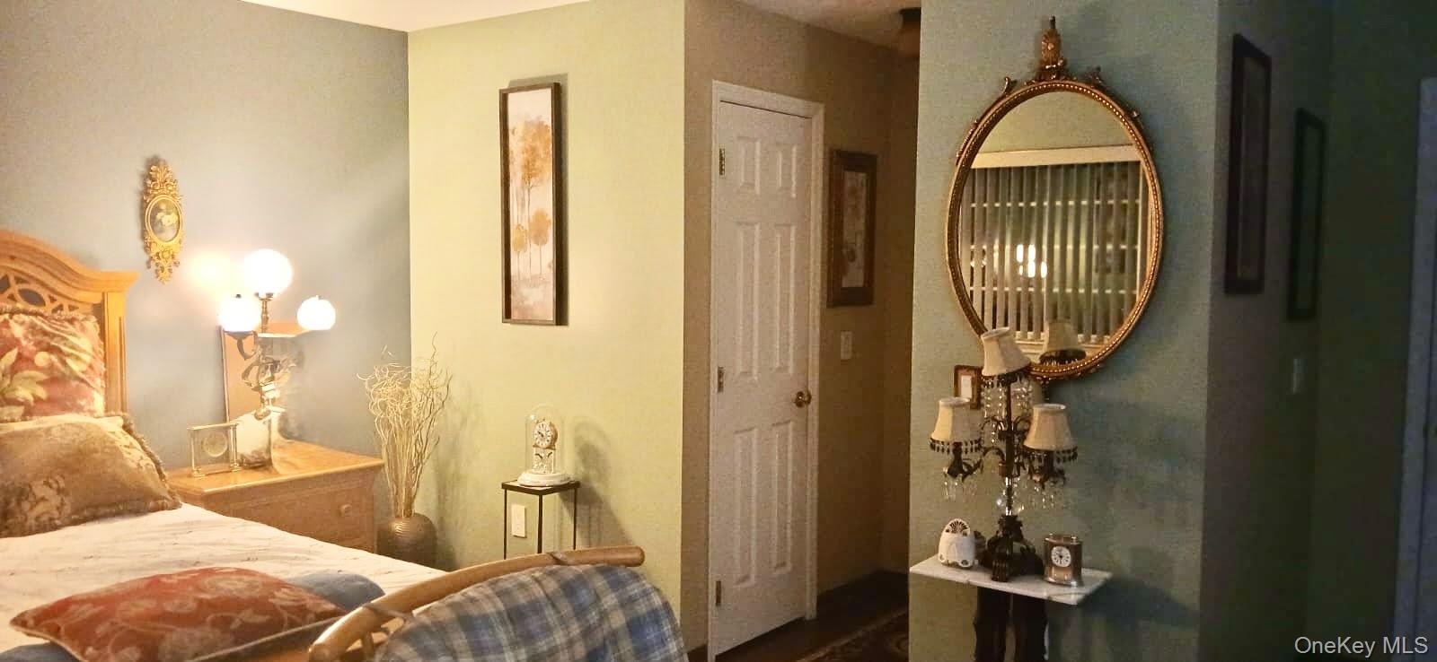 Six-panel interior door with brass-finish hardware and neutral-tone wall finishes