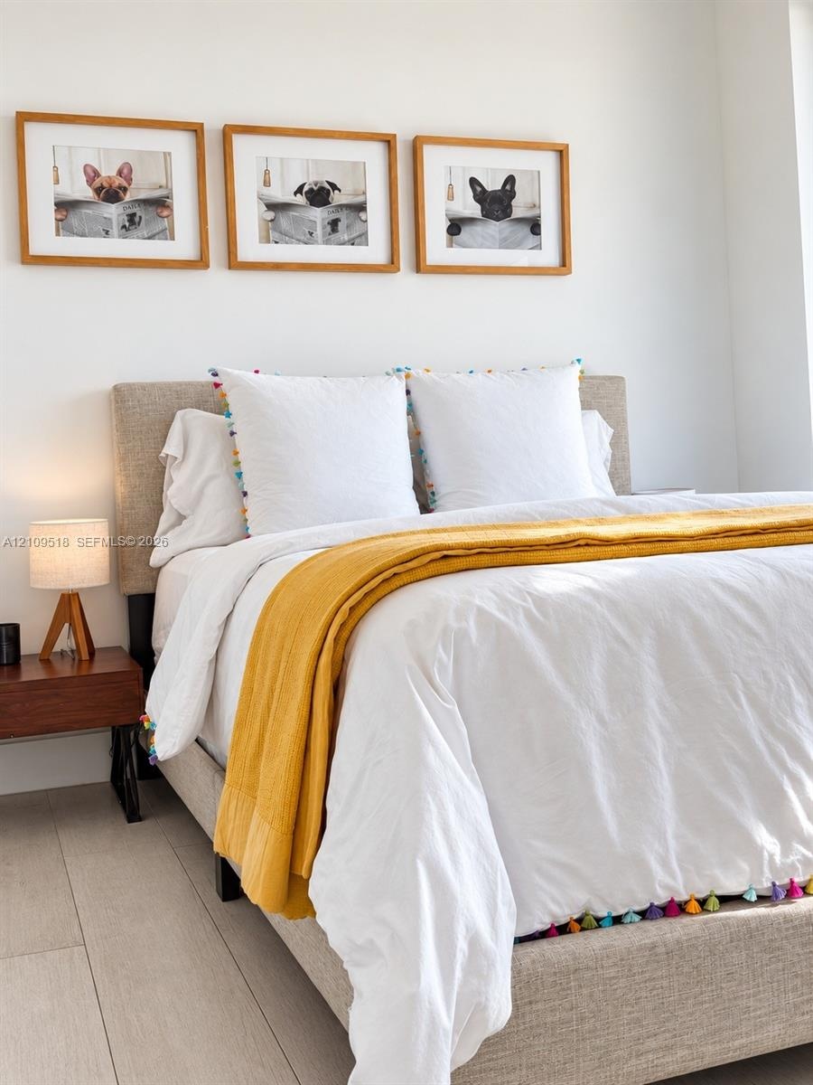 Neutral-toned wood-finish flooring and crisp white walls