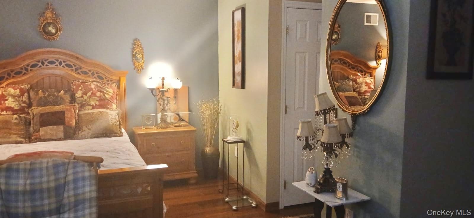 Wood-finish flooring and a white, six-panel interior door