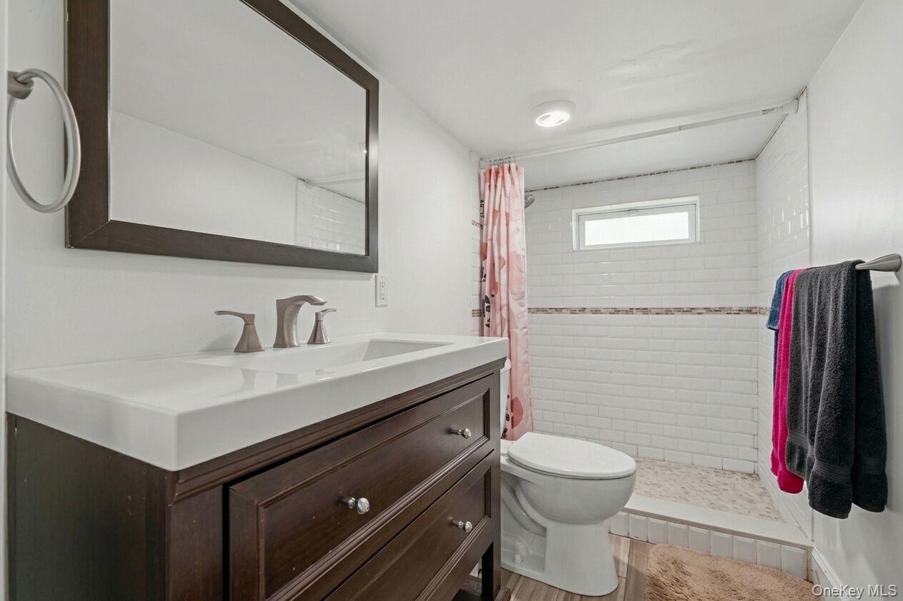 Dark wood-finish vanity with integrated sink
