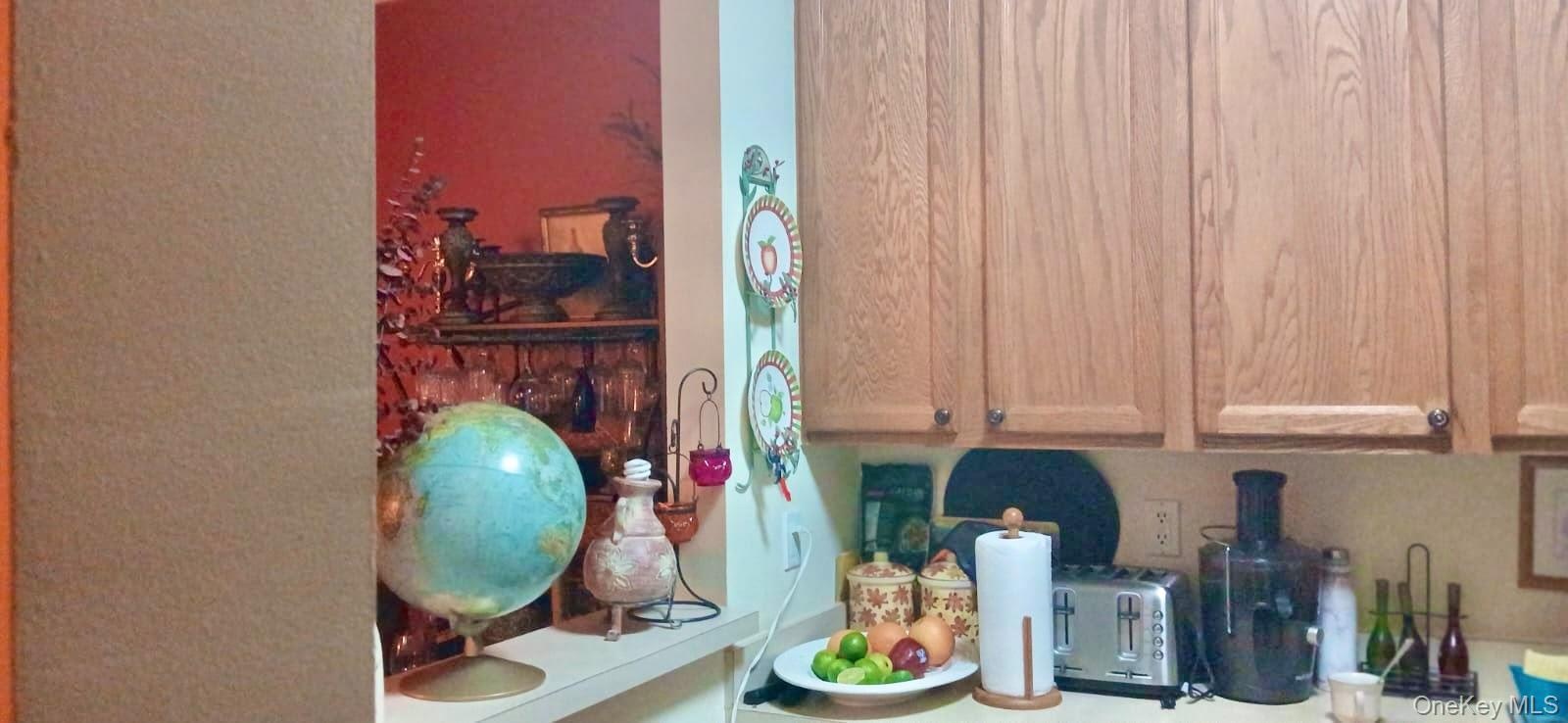 Kitchen featuring wood cabinetry and a passthrough opening