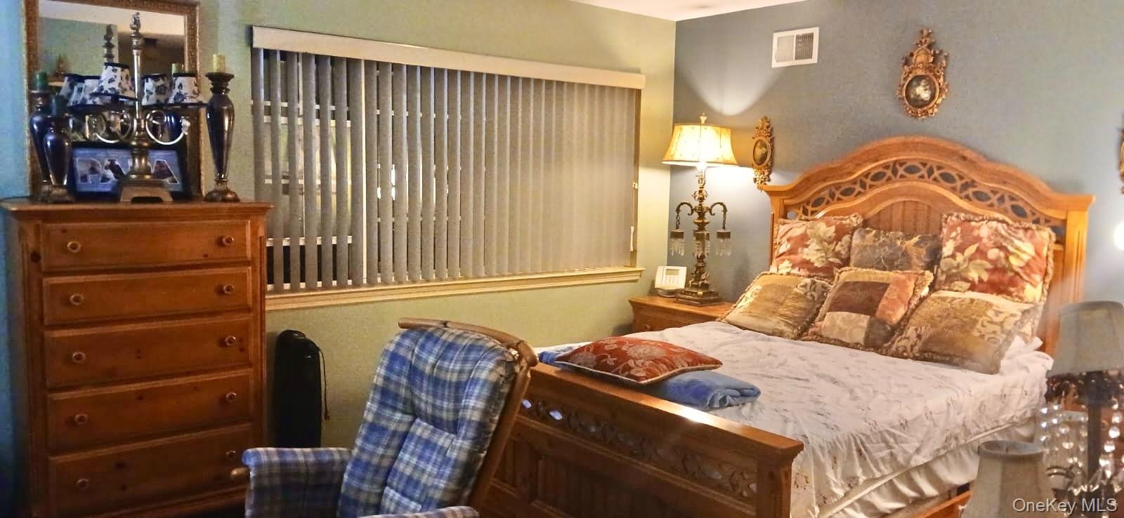 Room featuring vertical window blinds and painted interior walls