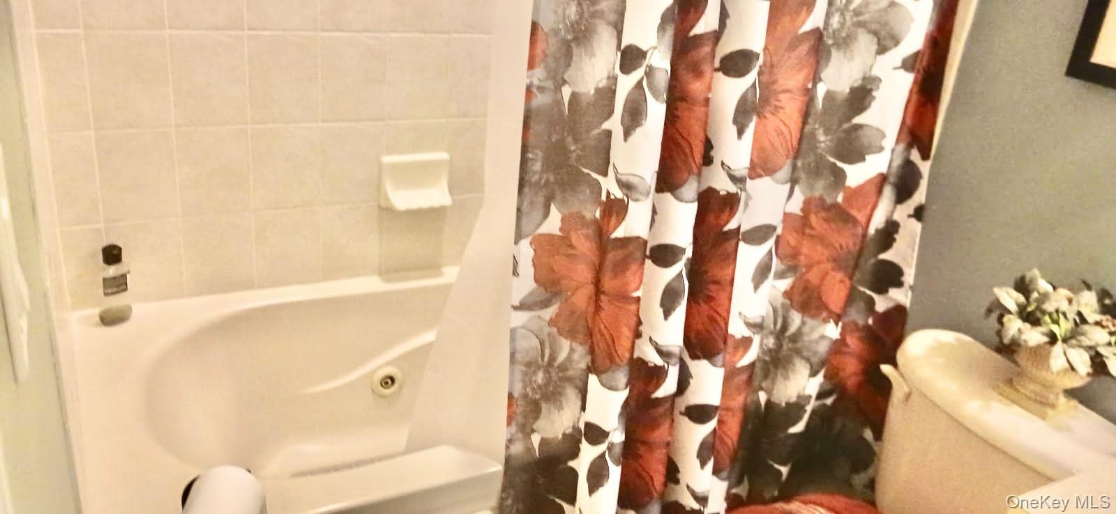 Built-in soaking tub with a porcelain-tiled surround and an integrated soap dish