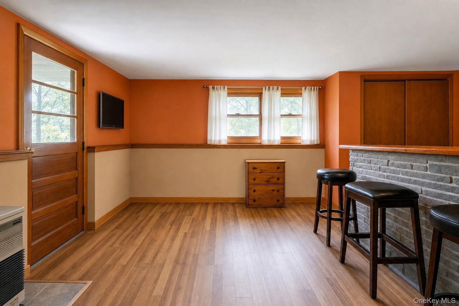 L-shaped family room with door to covered patio.