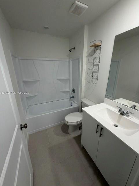 Bathroom featuring a white vanity cabinet with a stone countertop, integrated sink, large wall-mounted mirror, and a tub-shower combination with built