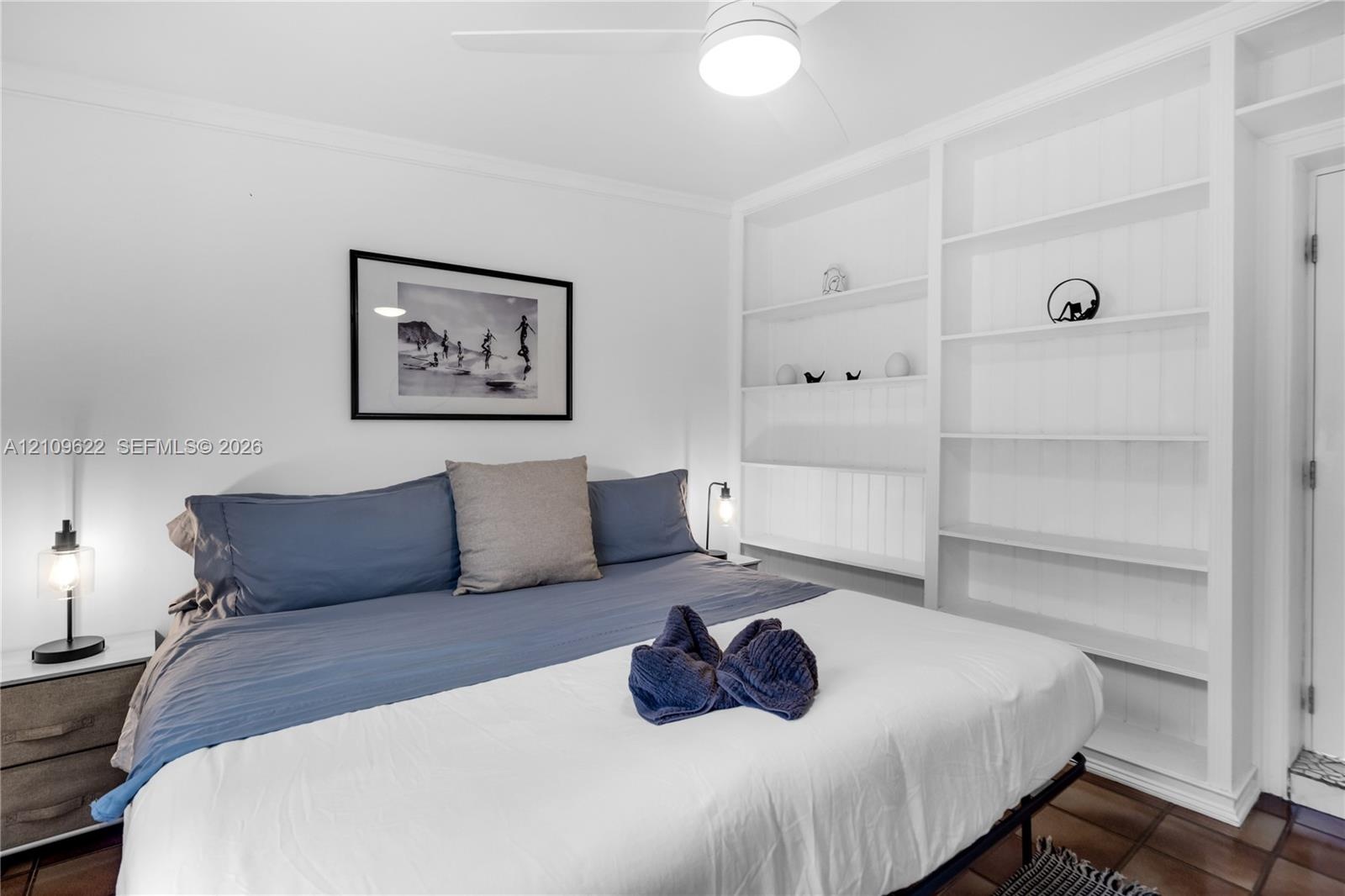 Built-in floor-to-ceiling shelving, recessed ceiling fan with integrated lighting, and tile flooring