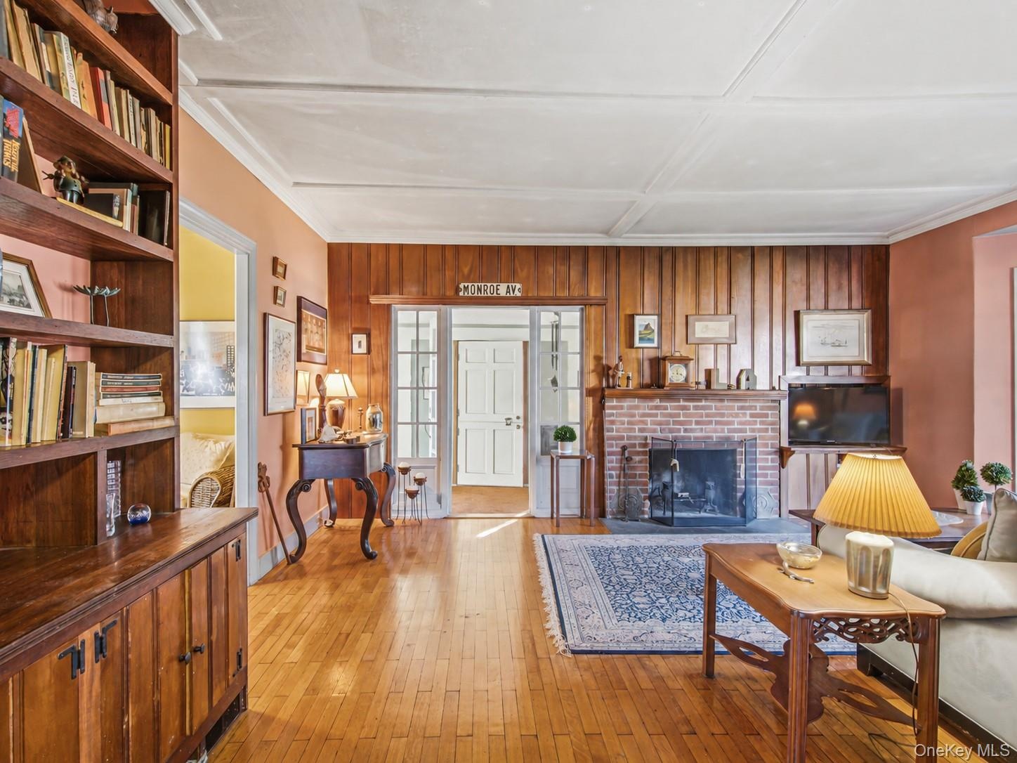 Main living room with built-ins and warm wood paneling.
