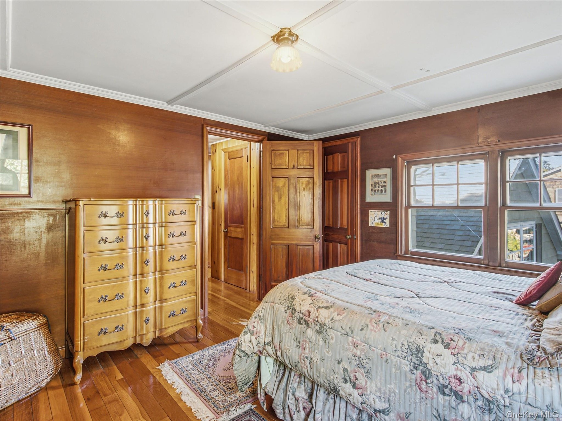 Bedroom with hardwood floors and views of the water