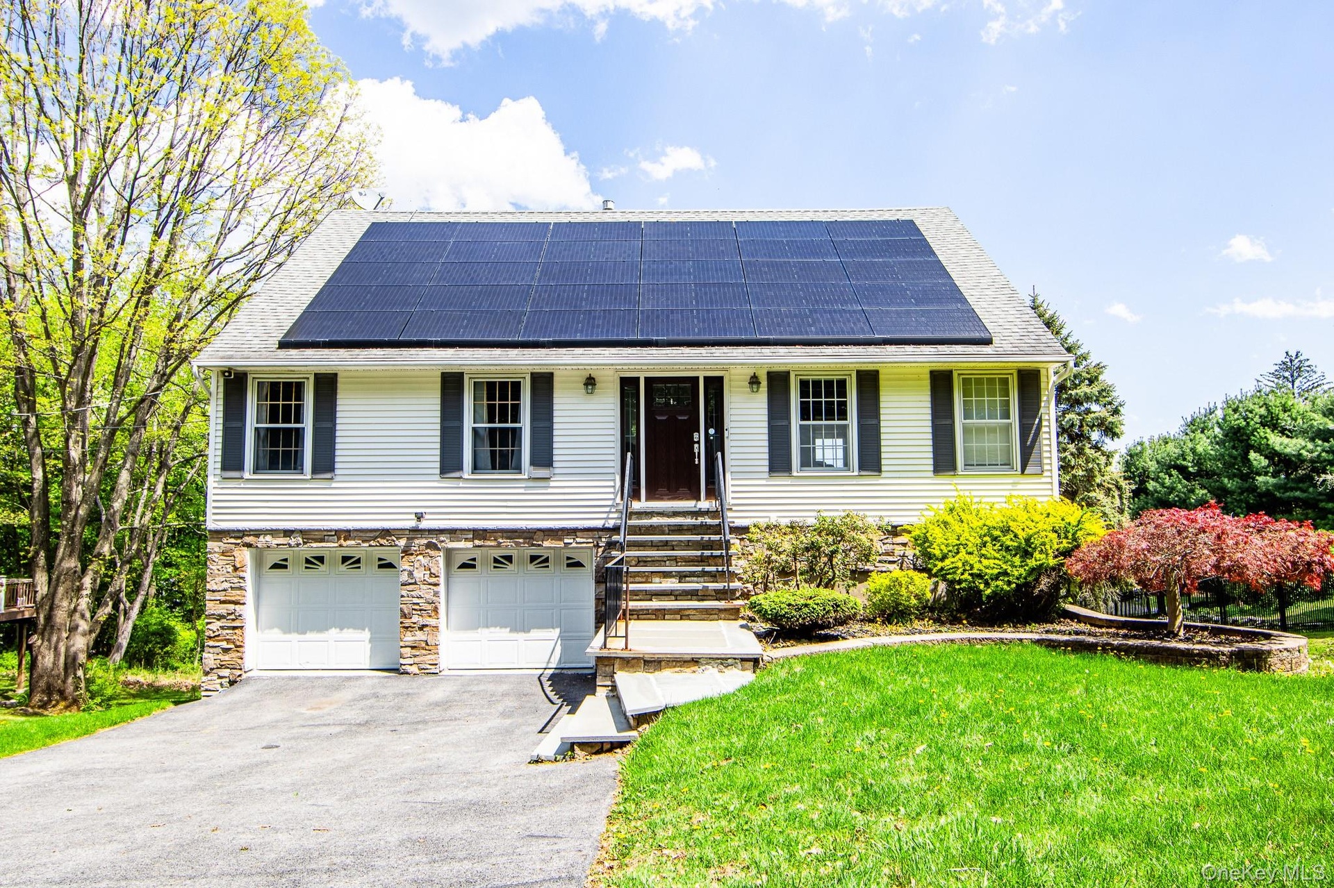 Contemporary cape with vinyl and stone front