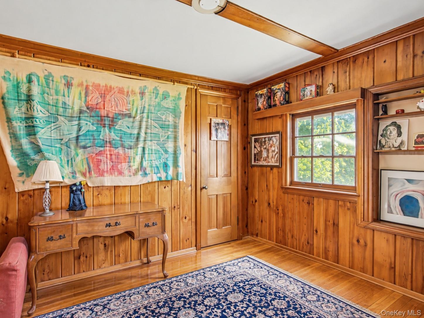 Bedroom with hardwood floors and walk-in closet